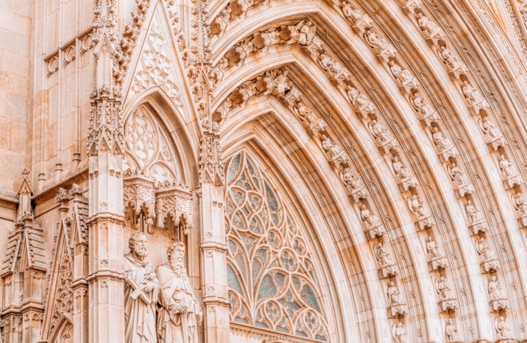 Neo-Gothic entrance façade of the Barcelona Cathedral at Pla de la Seu with sculpted saints and pointed arches.