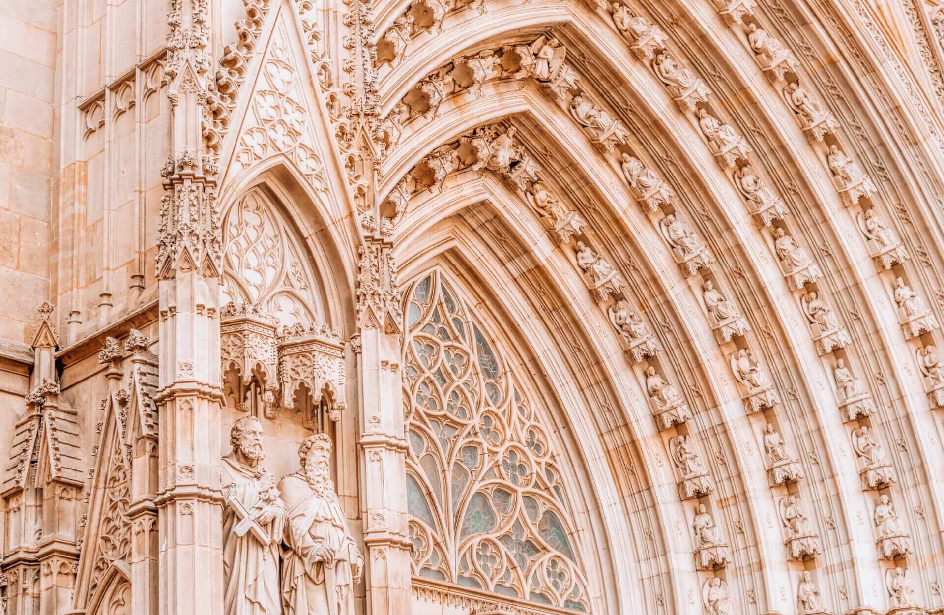 Neo-Gothic entrance façade of the Barcelona Cathedral at Pla de la Seu with sculpted saints and pointed arches.